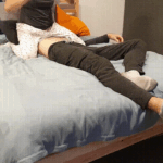 Playing the console sat on the face of her boyfriend
